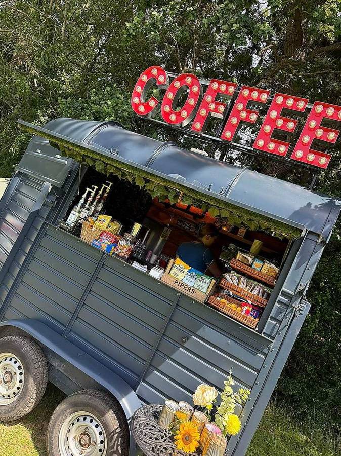 Snack baskets, syrups and the marquee sign on the slate blue horsebox van